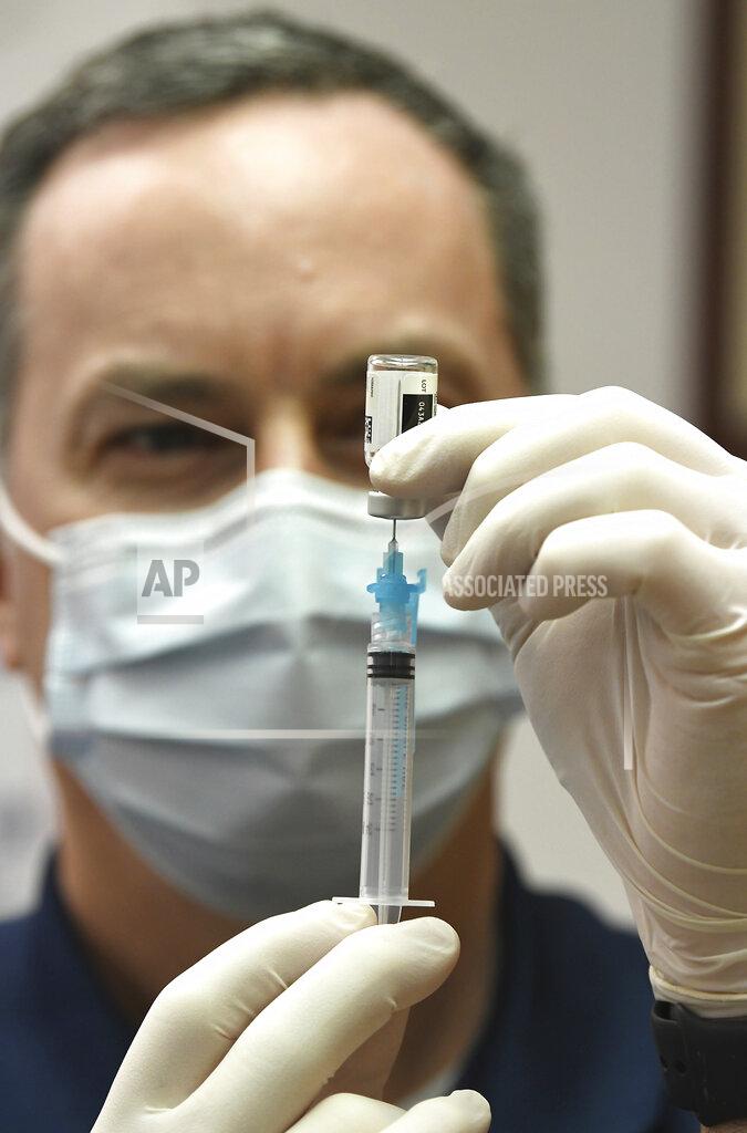 Pharmacist Dr. Joe Albert Fills a syringe with a Johnson & Johnson COVID vaccine at Albert's Pharmacy in Pittston, Pa., Monday April 12, 2021. https://www.youtube.com/watch?v=EUCLoPFvNKY