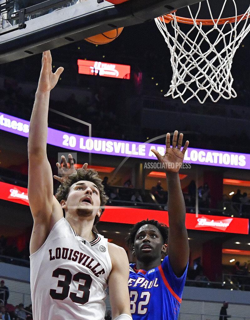 Timothy D. Easley Louisville forward Matt Cross (33) shoots in front of DePaul forward David Jones (32) during the second half of an NCAA college basketball game in Louisville, Ky., Friday, Dec. 10, 2021. (AP Photo/Timothy D. Easley)