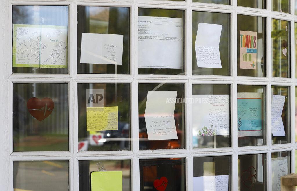 FILE - This May 14, 2020, file photo shows notes for healthcare workers taped in the front window at the Kimberly Hall North nursing home in Windsor, Conn. Nursing home residents account for nearly 1 in 10 of all the coronavirus cases in the United States and more than a quarter of the deaths, according to an Associated Press analysis of government data released Thursday, June 18. (AP Photo/Chris Ehrmann, File)
