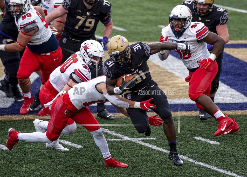 Daniel Lin James Madison running back Percy Agyei-Obese (31) gets wrapped up by Richmond defensive back Gio Seigler (13) during the second half of an NCAA college football game in Harrisonburg, Va., Saturday, April 17, 2021. (Daniel Lin/Daily News-Record Via AP)