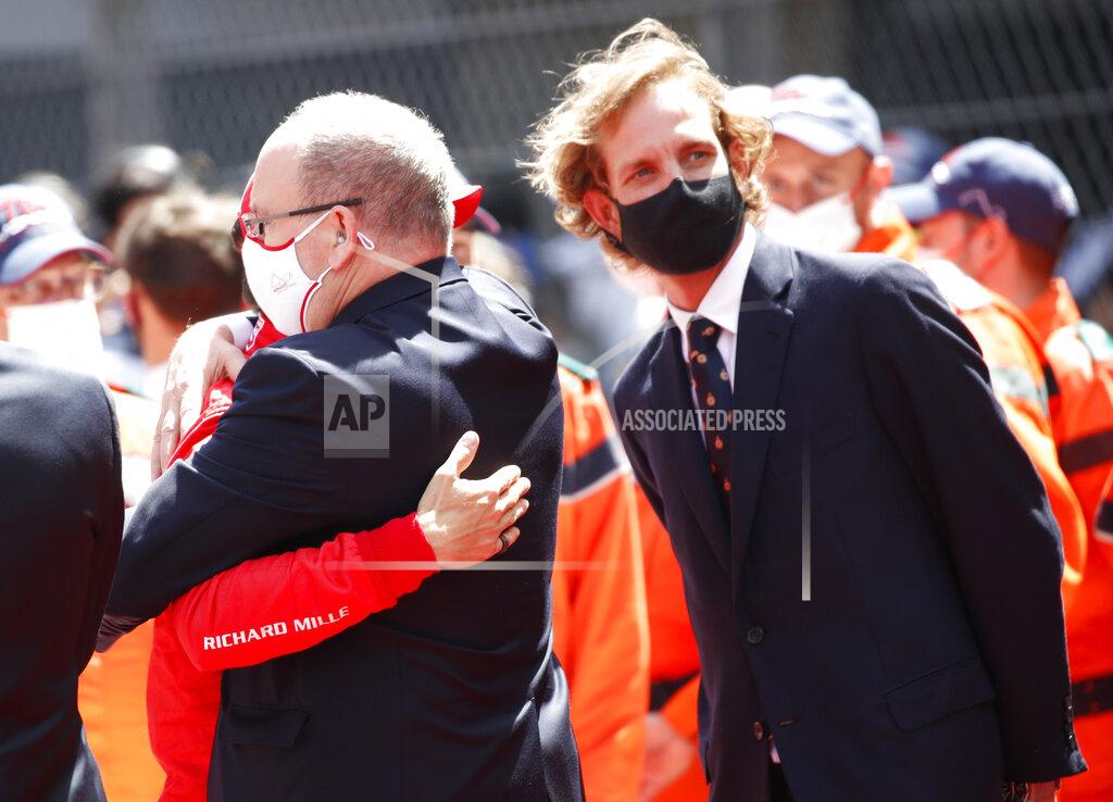 Sebastien Nogier Prince Albert II of Monaco, center, embraces Ferrari driver Charles Leclerc of Monaco prior to the start of the Monaco Grand Prix at the Monaco racetrack, in Monaco, Sunday, May 23, 2021. (Sebastien Nogier, Pool via AP)