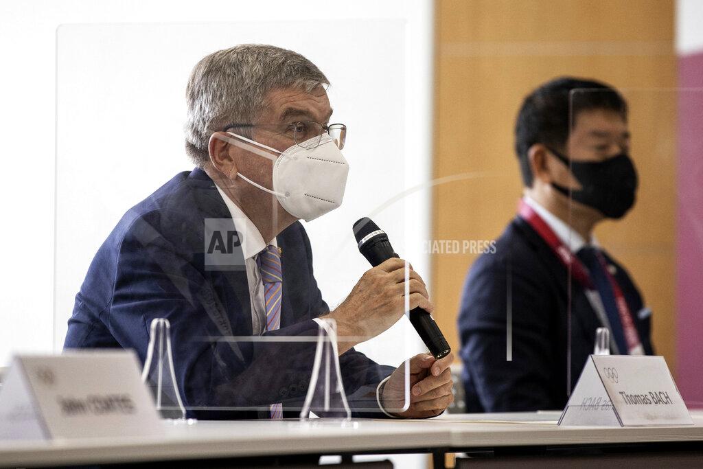 IOC President Thomas Bach, left, speaks to Tokyo 2020 President Seiko Hashimoto, not in photo, during their meeting at the Tokyo 2020 Headquarters Tuesday, July 13, 2021 in Tokyo, Japan. Bach appeared in public on Tuesday for the first time since arriving in Tokyo last week with the pandemic-postponed Olympics opening in just 10 days. (Takashi Aoyama/Pool Photo via AP)