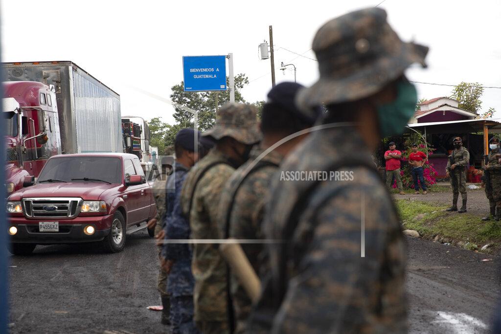 Moises Castillo A "Welcome to Guatemala" sign stands over moving vehicle traffic where soldiers stand guard in El Cinchado, Guatemala, on the border with Honduras, Friday, Oct. 2, 2020. Guatemala vowed to detain and return members of a new caravan of about 2,000 migrants that set out from neighboring Honduras in hopes of reaching the United States, saying they represent a health threat amid the coronavirus pandemic. (AP Photo/Moises Castillo)