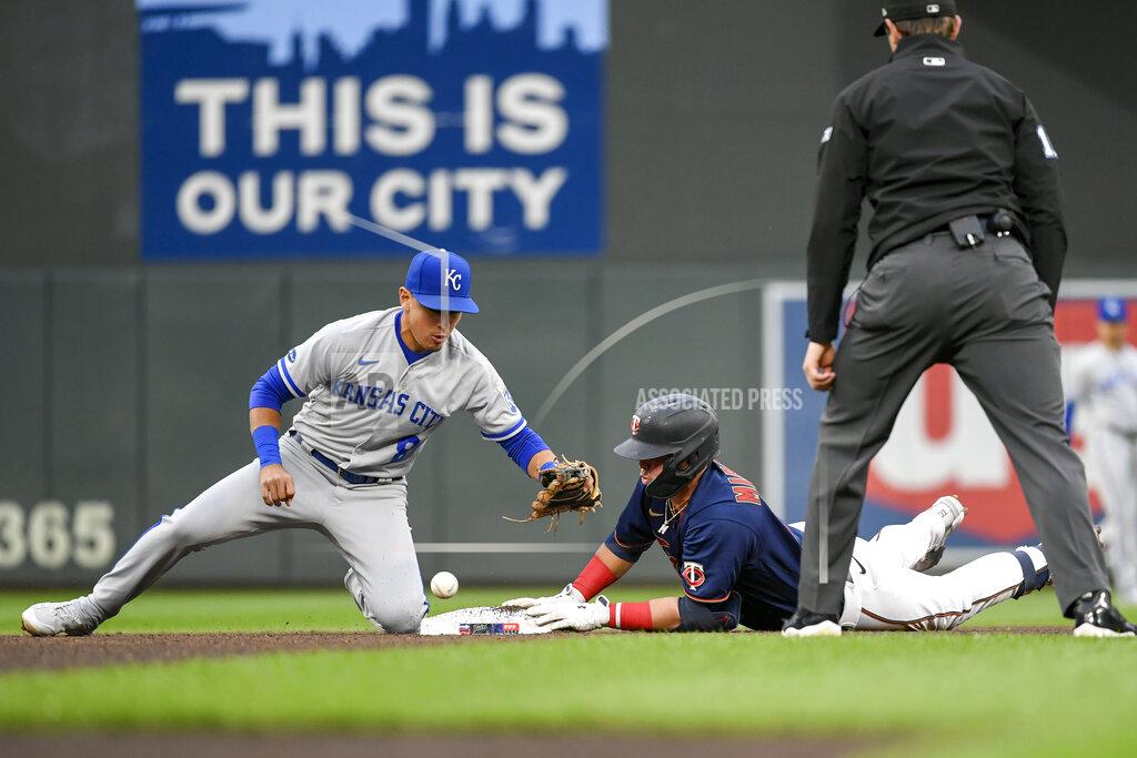 Craig Lassig Minnesota Twins' Jose Miranda, center, is safe at second base after hitting a double as Kansas City Royals second baseman Nicky Lopez can't hang on to the ball to make the tag, while umpire Adam Beck watches during the fourth inning of a baseball game Thursday, May 26, 2022, in Minneapolis. (AP Photo/Craig Lassig)