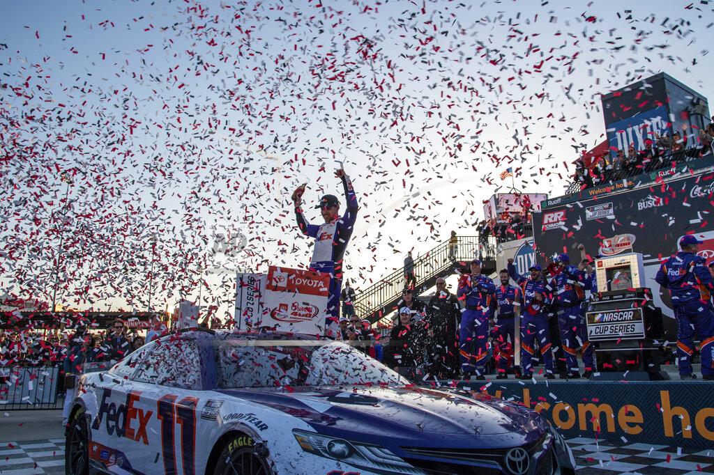 Mike Caudill Denny Hamlin raises his hands in Victory Lane after winning the NASCAR Cup Series auto race at Richmond Raceway on Sunday, April 3, 2022, in Richmond, Va. (AP Photo/Mike Caudill)