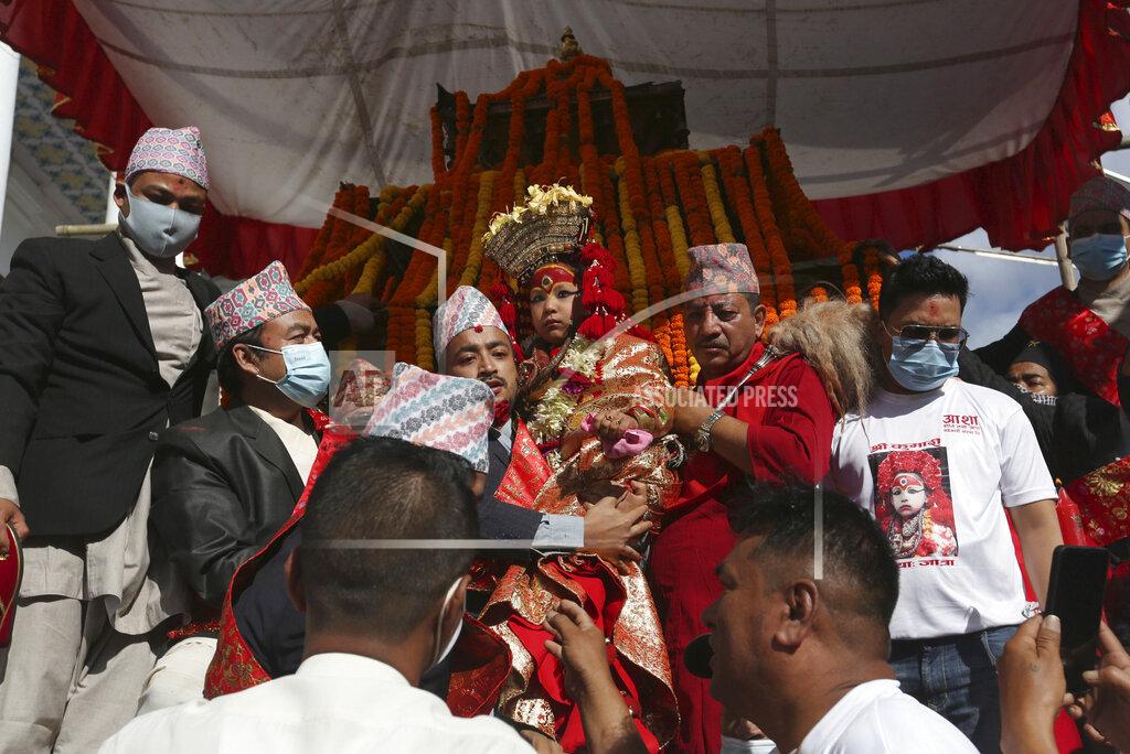 Niranjan Shrestha Nepal's revered living goddess Kumari is carried to be taken around in a wooden chariot during the annual Indra Jatra festival in Kathmandu, Nepal, Sunday, Sept. 19, 2021. The feast of Indra Jatra marks the return of the festival season in the Himalayan nation two years after it was scaled down because the pandemic. (AP Photo/Niranjan Shrestha)