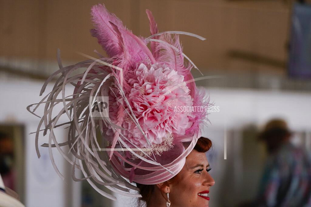 Charlie Riedel A women walks past wagering windows before the 147th running of the Kentucky Oaks at Churchill Downs, Friday, April 30, 2021, in Louisville, Ky. (AP Photo/Charlie Riedel)