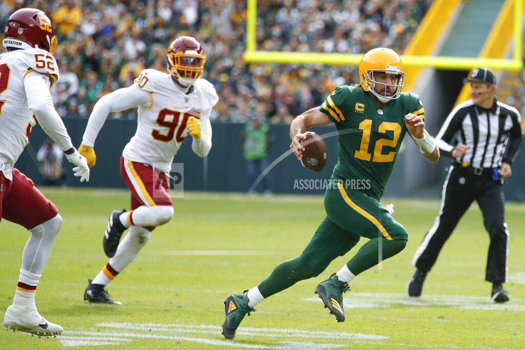 Matt Ludtke Green Bay Packers' Aaron Rodgers runs during the first half of an NFL football game against the Washington Football Team Sunday, Oct. 24, 2021, in Green Bay, Wis. (AP Photo/Matt Ludtke)