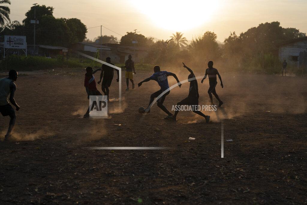 Leo Correa Youths play soccer during as the sun sets in Koidu, district of Kono, Sierra Leone, Tuesday, Nov. 24, 2020. (AP Photo/Leo Correa)