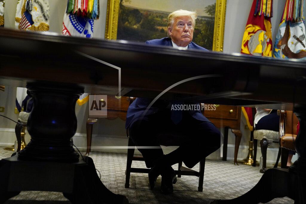 Evan Vucci President Donald Trump listens during a conference call with banks on efforts to help small businesses during the coronavirus pandemic, at the White House, Tuesday, April 7, 2020, in Washington. (AP Photo/Evan Vucci)