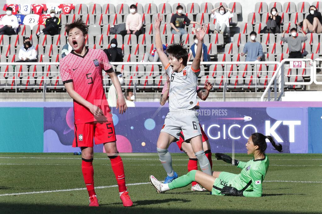 China's Zhang Xin, second from right, celebrates after scoring the first goal against South Korea during the Asian qualifying for the 2020 Tokyo Olympics at the Goyang stadium in Goyang, South Korea, Thursday, April 8, 2021. (AP Photo/Ahn Young-joon)