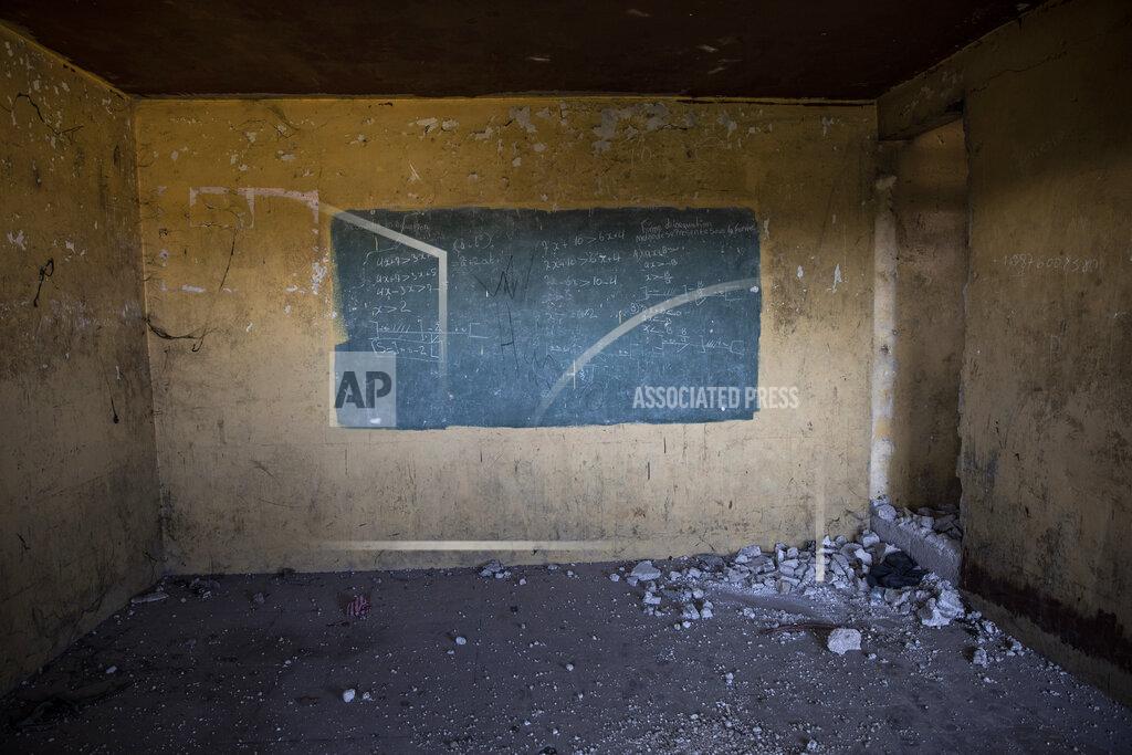 Rodrigo Abd Algebraic equations cover a painted green rectangle serving as a chalkboard in an abandoned classroom in Fort Dimanche, once a prison where the late Haitian dictator Francois "Papa Doc" Duvalier imprisoned his enemies, in Port-au-Prince, Haiti, Thursday, Sept. 23, 2021. (AP Photo/Rodrigo Abd)