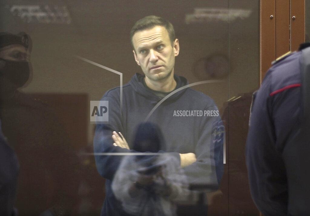 Uncredited In this image made from video provided by the Babuskinsky District Court, Russian opposition leader Alexei Navalny stands in a cage during a hearing on his charges for defamation, in the Babuskinsky District Court in Moscow, Russia, Friday, Feb. 5, 2021. Navalny was accused of slandering a World War II veteran featured in the video promoting the constitutional reform allowing to extend President Vladimir Putin's rule. The politician slammed people in the video as "corrupt stooges" and "traitors." (Babuskinsky District Court via AP)