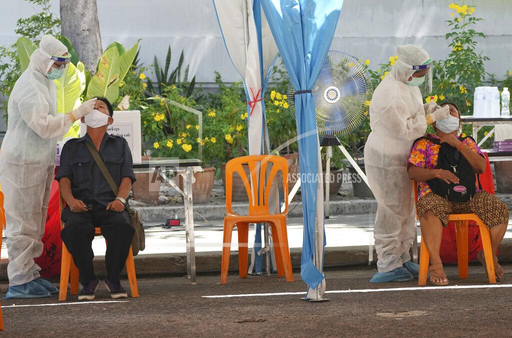 Sakchai Lalit Health workers collect nasal swabs from local residents for coronavirus testing in Bangkok, Thailand, Tuesday, June 1, 2021. (AP Photo/Sakchai Lalit)