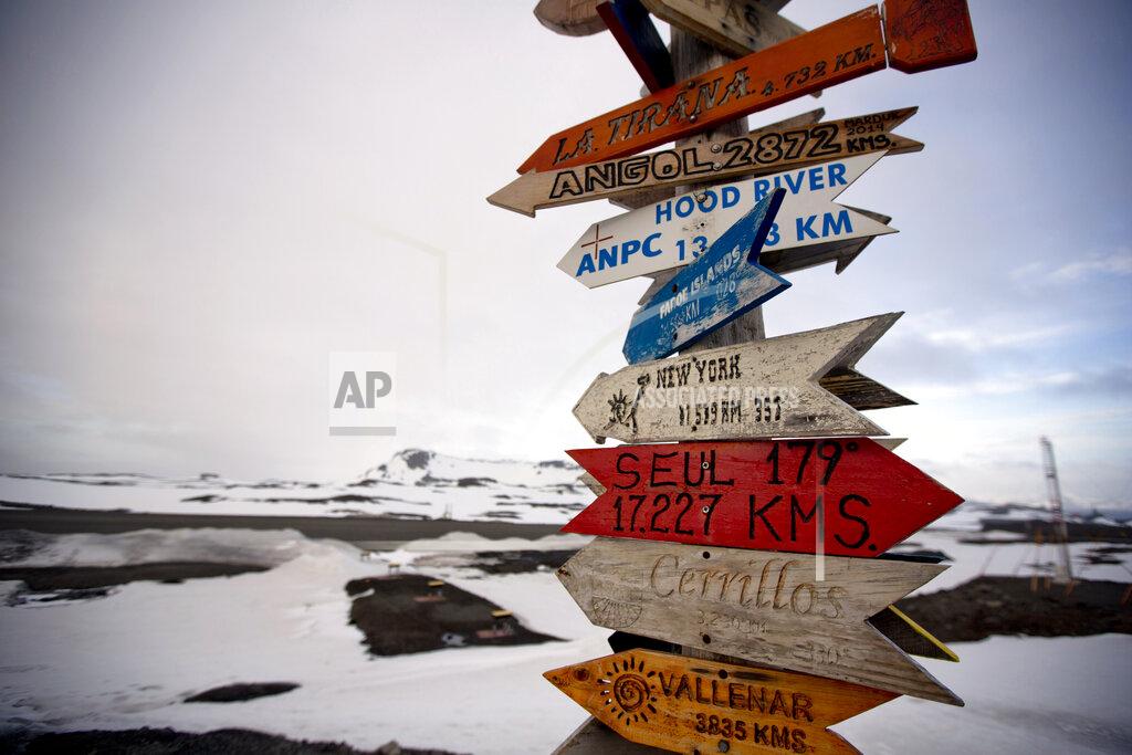 Natacha Pisarenko FILE - In this Jan. 20, 2015, file photo, wooden arrows show the distances to various cities on King George Island, Antarctica. There has been perhaps no place on earth where authorities have been more vigilant in keeping out the virus than Antarctica, the only continent which remains virus-free. (AP Photo/Natacha Pisarenko, File)