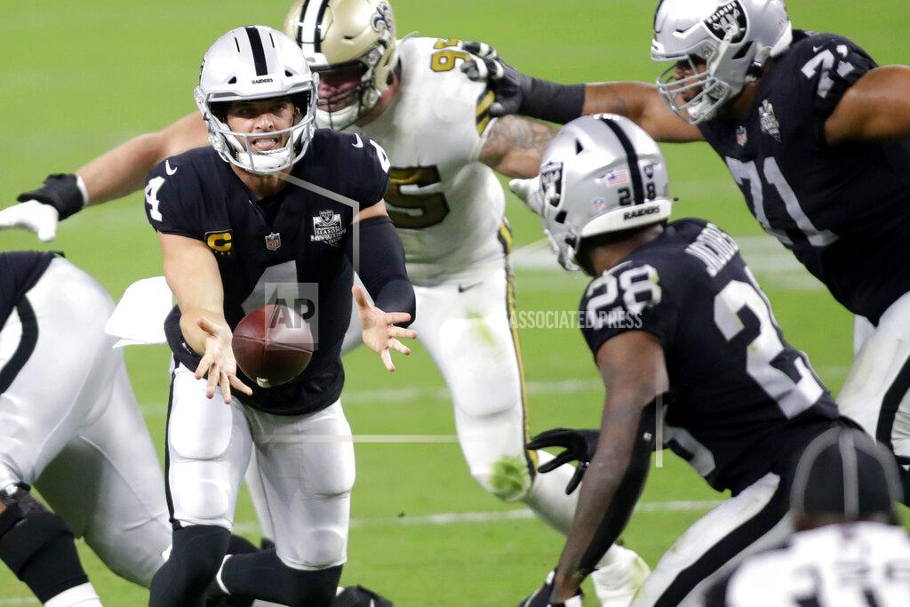 Isaac Brekken Las Vegas Raiders quarterback Derek Carr (4) throws the ball to running back Josh Jacobs (28) during the second half of an NFL football game, Monday, Sept. 21, 2020, in Las Vegas. (AP Photo/Isaac Brekken)