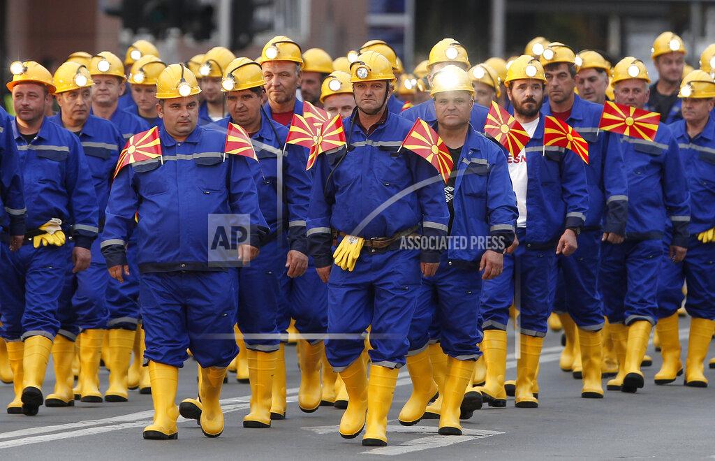 Boris Grdanoski Miners take part in a parade during the Independence Day in downtown Skopje, North Macedonia, Wednesday, Sept. 8, 2021. North Macedonia is marking Wednesday the 30th anniversary since its independence from former Yugoslavia. (AP Photo/Boris Grdanoski)