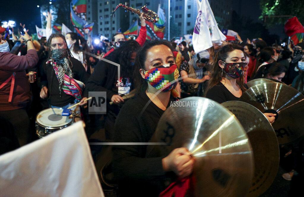 Esteban Felix People play instruments at Plaza Italia on the day Chileans vote in a referendum to decide whether the country should replace its 40-year-old constitution, written during the dictatorship of Gen. Augusto Pinochet, in Santiago, Chile, Sunday, Oct. 25, 2020. (AP Photo/Esteban Felix)