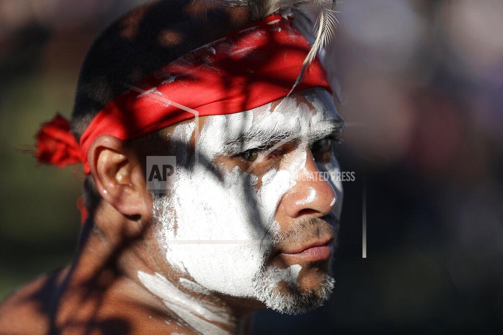 Rick Rycroft Russell Dawson of the Koomurri Aboriginal Dancers participates in a smoking ceremony during Australia Day ceremonies in Sydney, Tuesday, Jan. 26, 2021. (AP Photo/Rick Rycroft)