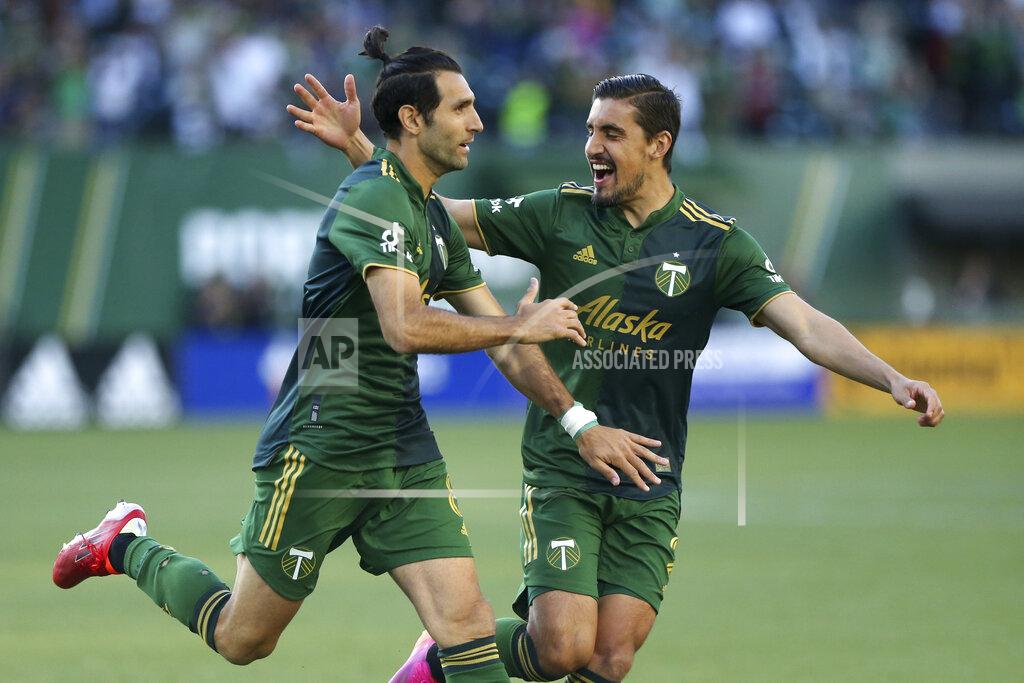 Sean Meagher Portland Timbers midfielder Diego Valeri, left, and defender Josecarlos Van Rankin celebrate after Valeri scores his 100th MLS goal, against Los Angeles FC during the first half of an MLS soccer match Wednesday, July 21, 2021, in Portland, Ore. (Sean Meagher/The Oregonian via AP)