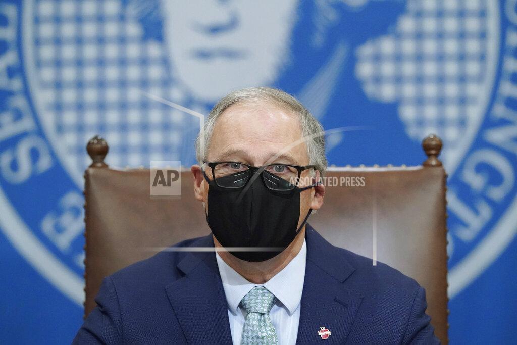 Washington Gov. Jay Inslee wears a mask as he speaks at a news conference, Tuesday, Jan. 5, 2021, at the Capitol in Olympia, Wash. Inslee said some COVID-19 restrictions in Washington will be eased beginning next week and the state will change its reopening plan to move from a county-based oversight system to one focused on regions. (AP Photo/Ted S. Warren)