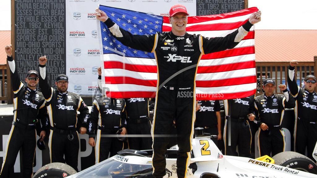 Tom E. Puskar Josef Newgarden celebrates in victory lane after winning an IndyCar race at Mid-Ohio Sports Car Course in Lexington, Ohio, Sunday, July 4, 2021. (AP Photo/Tom E. Puskar)
