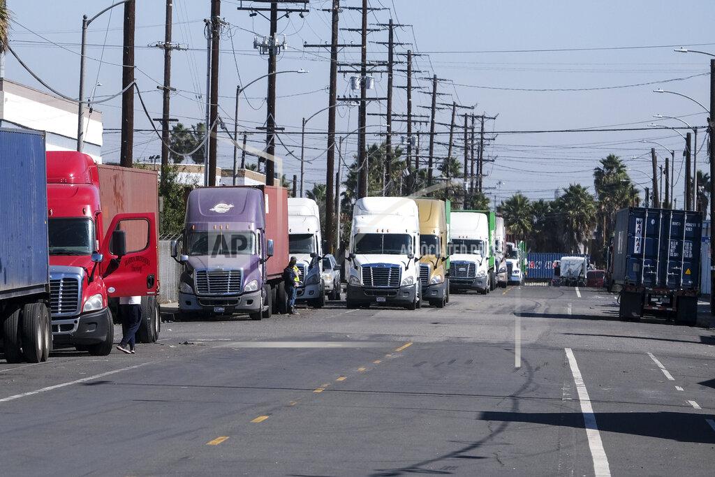 Ringo H.W. Chiu Parked cargo container trucks are seen in a street, Wednesday, Oct. 20, 2021 in Wilmington, Calif. California Gov. Gavin Newsom on Wednesday issued an order that aims to ease bottlenecks at the ports of Los Angeles and Long Beach that have spilled over into neighborhoods where cargo trucks are clogging residential streets. (AP Photo/Ringo H.W. Chiu)