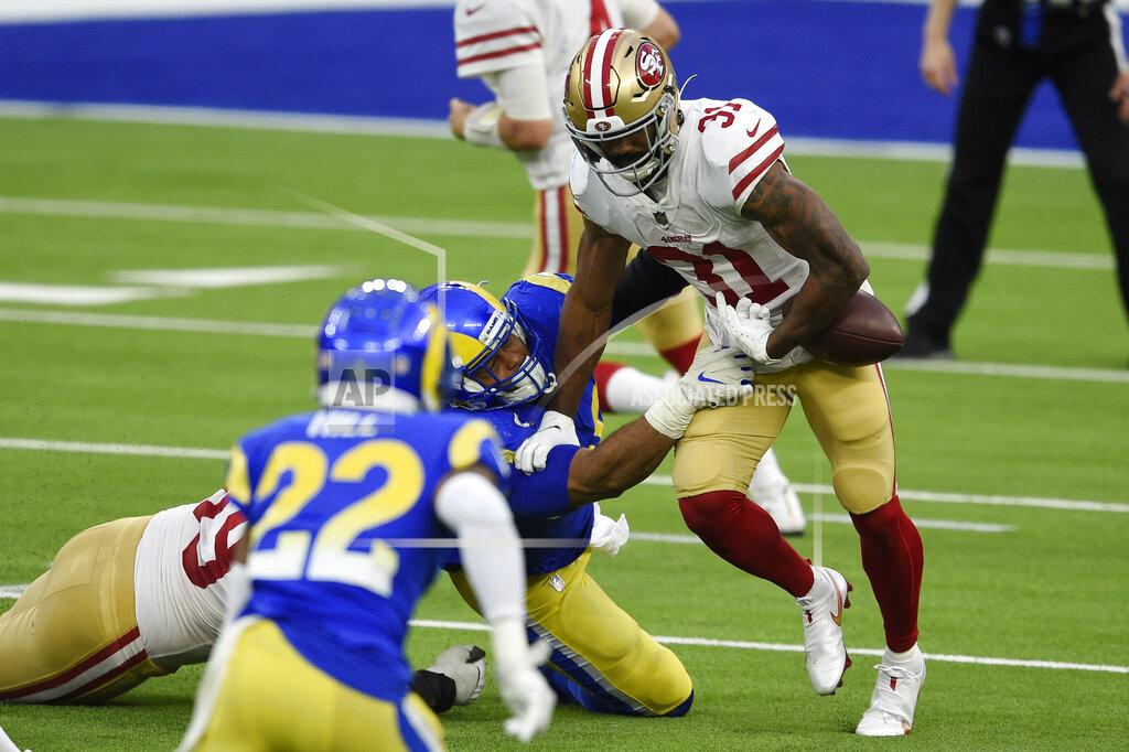 Kelvin Kuo San Francisco 49ers running back Raheem Mostert, right, fumbles the ball as he is tackled by Los Angeles Rams defensive end Aaron Donald during the second half of an NFL football game Sunday, Nov. 29, 2020, in Inglewood, Calif. The ball was recovered by Rams cornerback Troy Hill (22) who ran the ball back for a touchdown. (AP Photo/Kelvin Kuo)