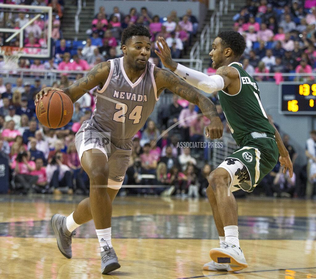 Tom R. Smedes Nevada forward Jordan Caroline (24) drives past Colorado State guard Hyron Edwards (0) during the first half of an NCAA college basketball game in Reno, Nev., Wednesday, Jan. 23, 2019. (AP Photo/Tom R. Smedes)
