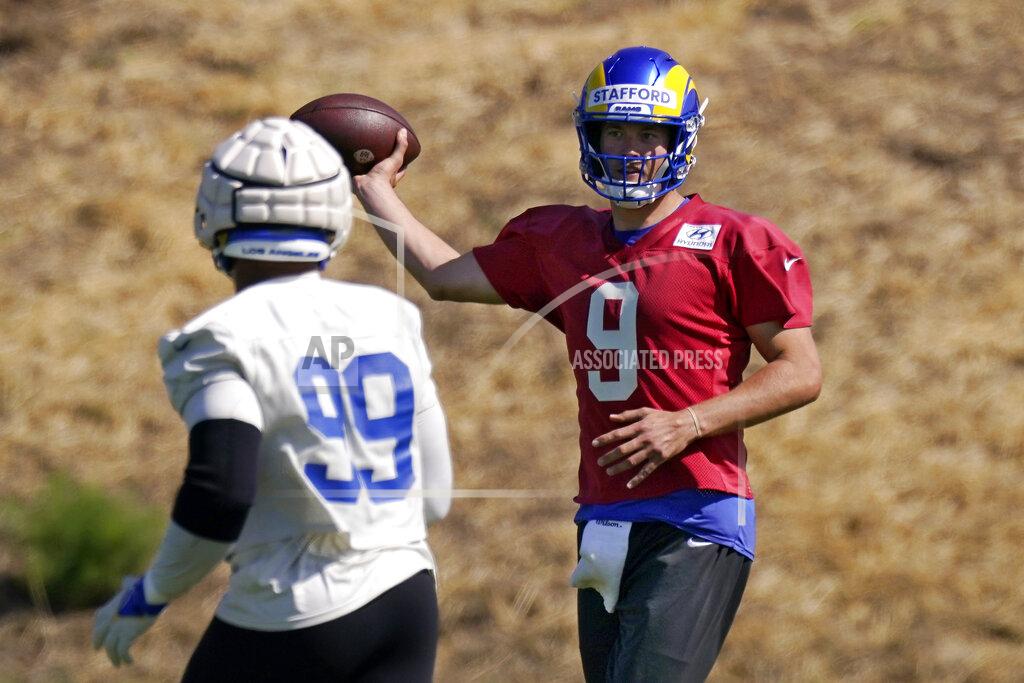Mark J. Terrill Los Angeles Rams quarterback Matthew Stafford, right fakes a pass as defensive end Aaron Donald stands by during an NFL mini camp football practice Tuesday, June 7, 2022, in Thousand Oaks, Calif. (AP Photo/Mark J. Terrill)
