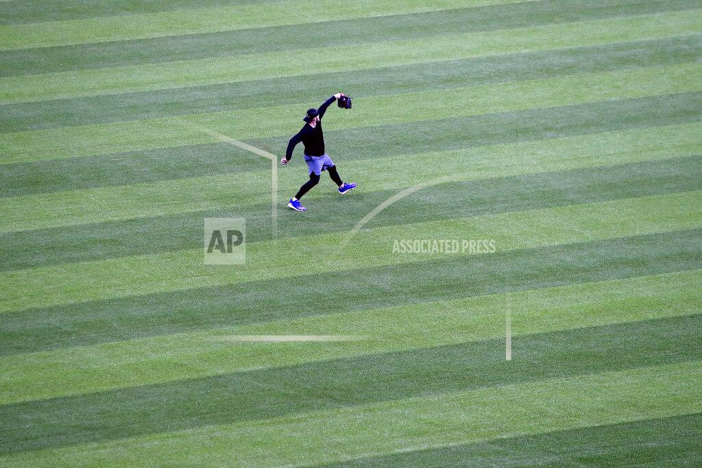 Lm Otero An unidentified player throws in the outfield at Globe Life Field, home of the Texas Rangers baseball team, in Arlington, Texas, Monday, June 1, 2020. The coronavirus pandemic has forced universities, leagues and franchises to evaluate how they might someday welcome back fans. While opinions vary from sport to sport, nation to nation and even state to state, one thing seems clear: Social distancing is very much a sure bet when fans return. (AP Photo/LM Otero)