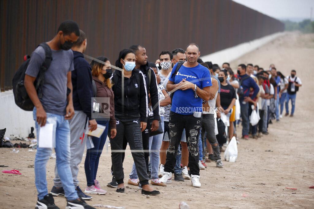 Dario Lopez-Mills Migrants who had crossed the Rio Grande river into the U.S. wait to be processed by Border Patrol agents in Eagle Pass, Texas, Friday, May 20, 2022. As U.S. officials anxiously waited, many of the migrants crossing the border from Mexico on Friday were oblivious to a pending momentous court ruling on whether to maintain pandemic-related powers that deny a chance to seek asylum on grounds of preventing the spread of COVID-19. (AP Photo/Dario Lopez-Mills)