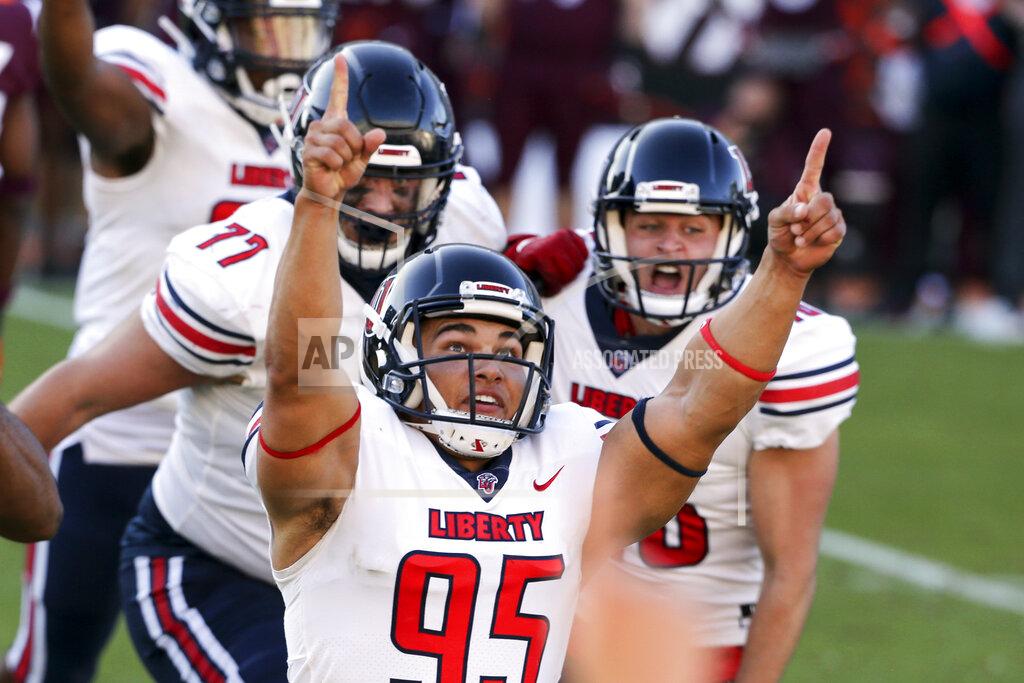 Matt Gentry FILE - In this Saturday, Nov. 7 2020, file photo, Liberty's Alex Barbir (95) celebrates kicking the game-winning field goal in the last second of the fourth quarter of an NCAA college football game against Virginia Tech in Blacksburg, Va. An unusual college football season has produced some unexpected unbeaten teams dotting the AP Top 25 with about a month left. Led by No. 7 Cincinnati and No. 8 BYU, five teams from outside the Power Five conferences have yet to lose. (Matt Gentry/The Roanoke Times via AP, Pool, File)