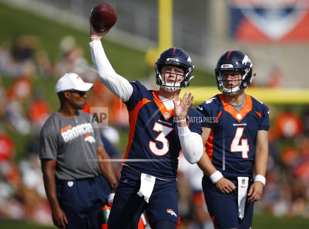 David Zalubowski Denver Broncos quarterback Drew Lock, front, warms up as quarterback Brett Rypien looks on during an NFL football training camp practice at the team's headquarters Tuesday, July 30, 2019, in Englewood, Colo. (AP Photo/David Zalubowski)