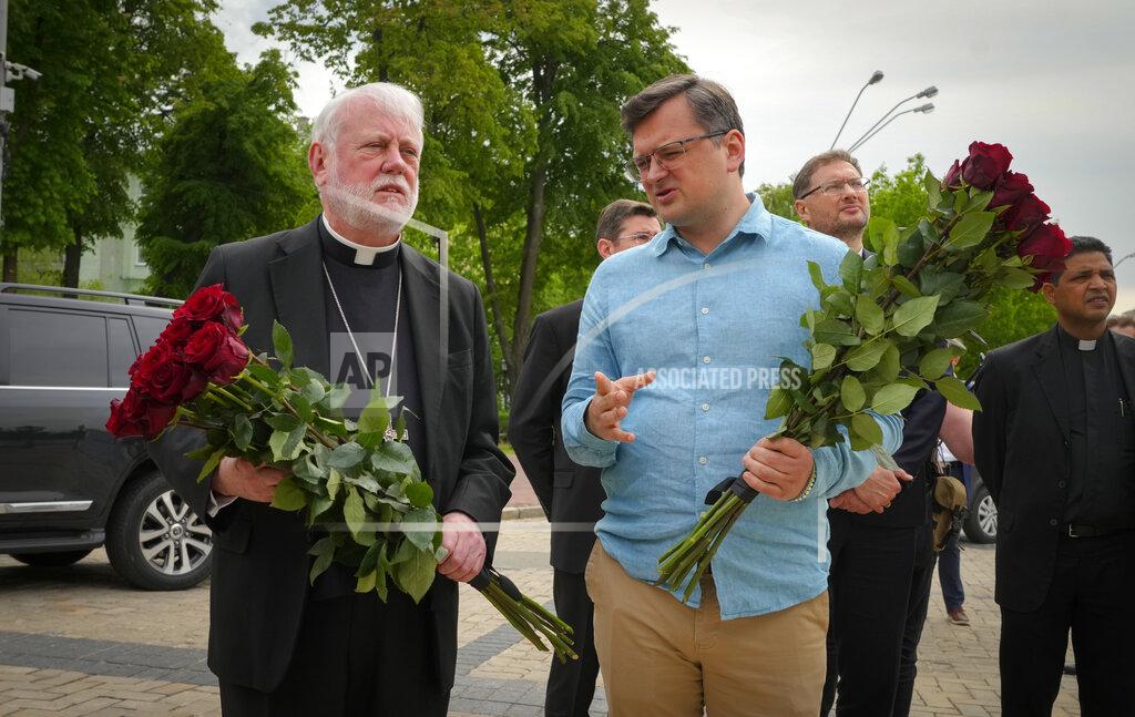 Efrem Lukatsky Ukrainian Foreign Minister Dmytro Kuleba, right, and Vatican Secretary for Relations with States Archbishop Paul Richard Gallagher lay flowers at the Memorial Wall of Fallen Defenders of Ukraine in Russian-Ukrainian War in Kyiv, Ukraine, Friday, May 20, 2022. (AP Photo/Efrem Lukatsky)