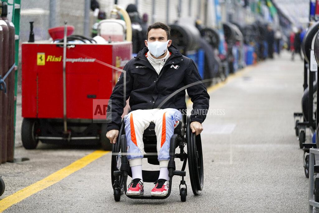 John Raoux FILE - Robert Wickens makes his way to his pit stall during practice for the Rolex 24 hour auto race at Daytona International Speedway, Thursday, Jan. 27, 2022, in Daytona Beach, Fla. Wickens used hand controls last weekend to win his first race since a 2018 spinal cord injury temporarily ended his racing career. Across an ocean, former IndyCar driver Sam Schmidt and motorcycle racer Wayne Rainey also piloted vehicles during the annual Goodwood Festival of Speed in England. (AP Photo/John Raoux, File)