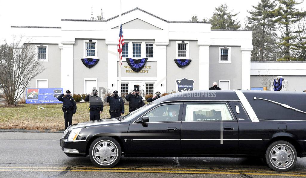 Mark Stockwell FILE - In this Thursday, Jan. 14, 2021. file photo, Norton, Mass. police salute as a hearse carrying colleague Det. Sgt. Stephen Desfosses briefly stops in front of the police station. Desfosses, 52, a local police officer for 32 years, died of the coronavirus Wednesday in Boston with members of his family by his side, Police Chief Brian Clark said in a statement. Coronavirus deaths are rising in nearly two-thirds of American states as a winter surge pushes the overall toll toward 400,000 amid warnings that a new, highly contagious variant is taking hold. (Mark Stockwell/The Sun Chronicle via AP)