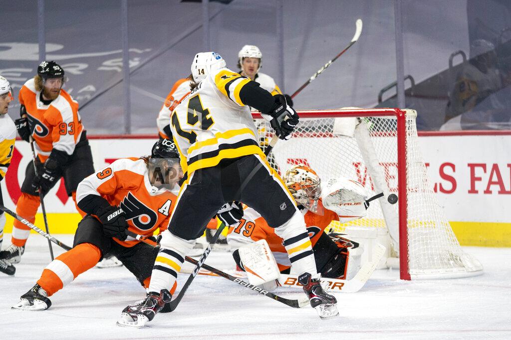 Chris Szagola Pittsburgh Penguins' Mark Jankowski, center, shoots the puck past Philadelphia Flyers' goaltender Carter Hart, right, for a goal during the first period of an NHL hockey game, Wednesday, Jan. 13, 2021, in Philadelphia. (AP Photo/Chris Szagola)