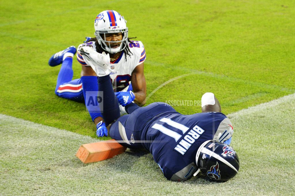 Mark Zaleski Tennessee Titans wide receiver A.J. Brown (11) hangs onto the ball after catching a touchdown pass as he was defended by Buffalo Bills cornerback Josh Norman (29) in the first half of an NFL football game Tuesday, Oct. 13, 2020, in Nashville, Tenn. (AP Photo/Mark Zaleski)