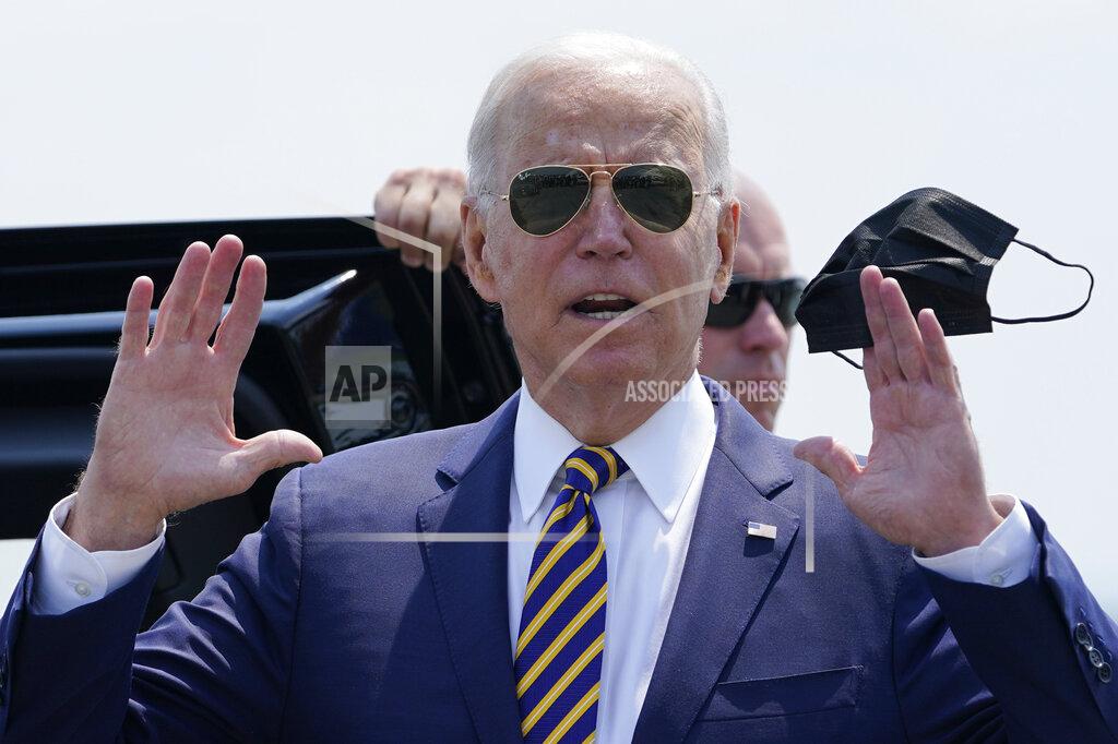 Susan Walsh President Joe Biden holds a mask as he responds to a question as he arrives at Lehigh Valley International Airport in Allentown, Pa., Wednesday, July 28, 2021. Biden is in the area to visit the Lehigh Valley operations facility for Mack Trucks and advocate for government investments and clean energy as ways to strengthen U.S. manufacturing. (AP Photo/Susan Walsh)