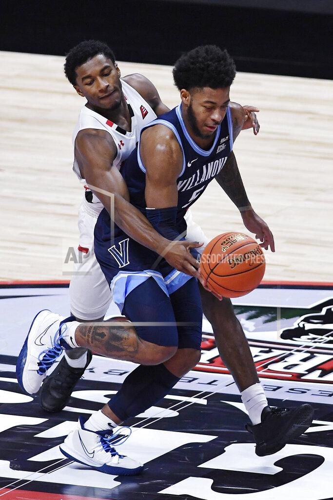 Jessica Hill Hartford's Moses Flowers, left, fouls Villanova's Justin Moore in the first half of an NCAA college basketball game, Tuesday, Dec. 1, 2020, in Uncasville, Conn. (AP Photo/Jessica Hill)