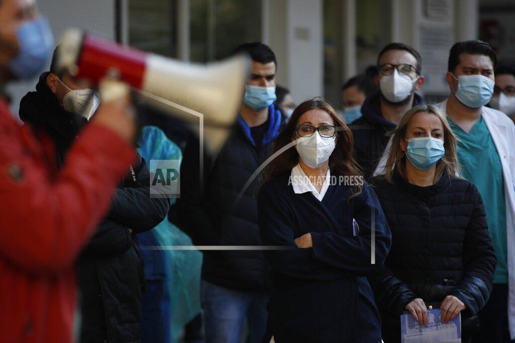 Medical staff gather during a rally to protest over a dispute with Evangelismos state hospital administration in Athens, Wednesday, March 31, 2021. Despite five months of lockdown measures, COVID-19 infections on Tuesday hit a new record in Greece. (AP Photo/Thanassis Stavrakis)