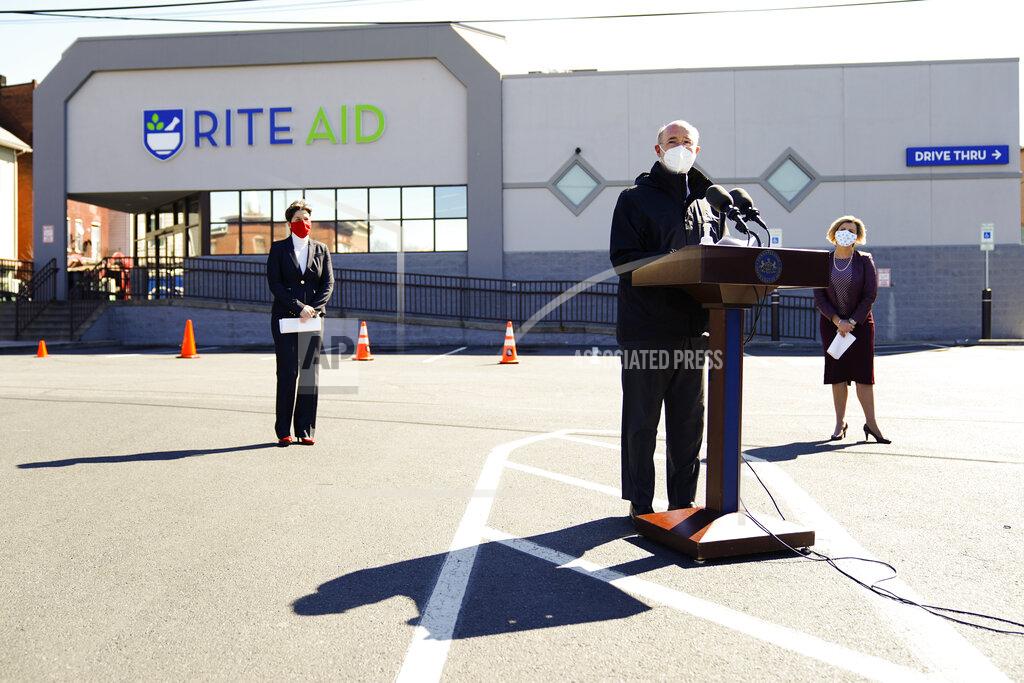 Matt Rourke Pennsylvania, Gov. Tom Wolf, center, accompanied by, Department of Human Services Secretary Teresa Miller, left, and Rite-Aid Chief Pharmacy Officer Jocelyn Konrad, speaks outside a Rite-Aid pharmacy in Steelton, Pa., that is administering COVID-19 vaccinations, Friday, March 5, 2021. (AP Photo/Matt Rourke)