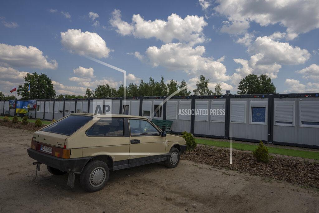 Nariman El-Mofty A car is parked in front of a trailer set up for temporary housing for people who lost their homes destroyed from Russian aerial bombs, in Borodyanka, Kyiv region, Ukraine, Tuesday, June 28, 2022. Trailers like this have become a popular way to offer a home to people who can't return to their own. In Borodyanka's camp live 257 people, 35% of them elderly residents (AP Photo/Nariman El-Mofty)
