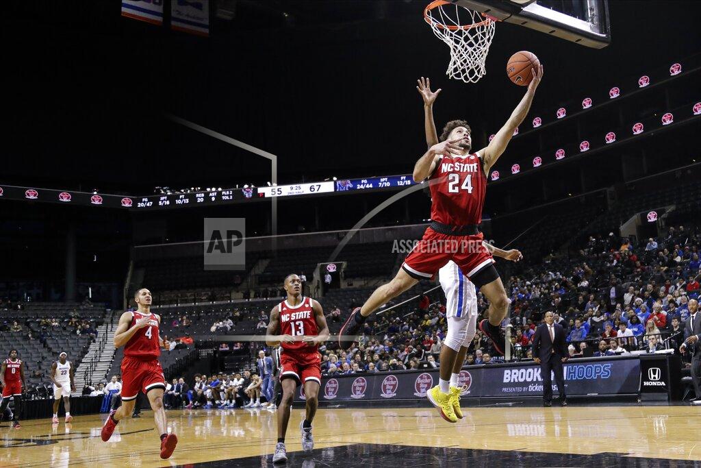 Frank Franklin Ii North Carolina State's Devon Daniels (24) drives past Memphis' Jayden Hardaway during the second half of an NCAA college basketball game in the Barclays Classic, Thursday, Nov. 28, 2019, in New York. (AP Photo/Frank Franklin II)