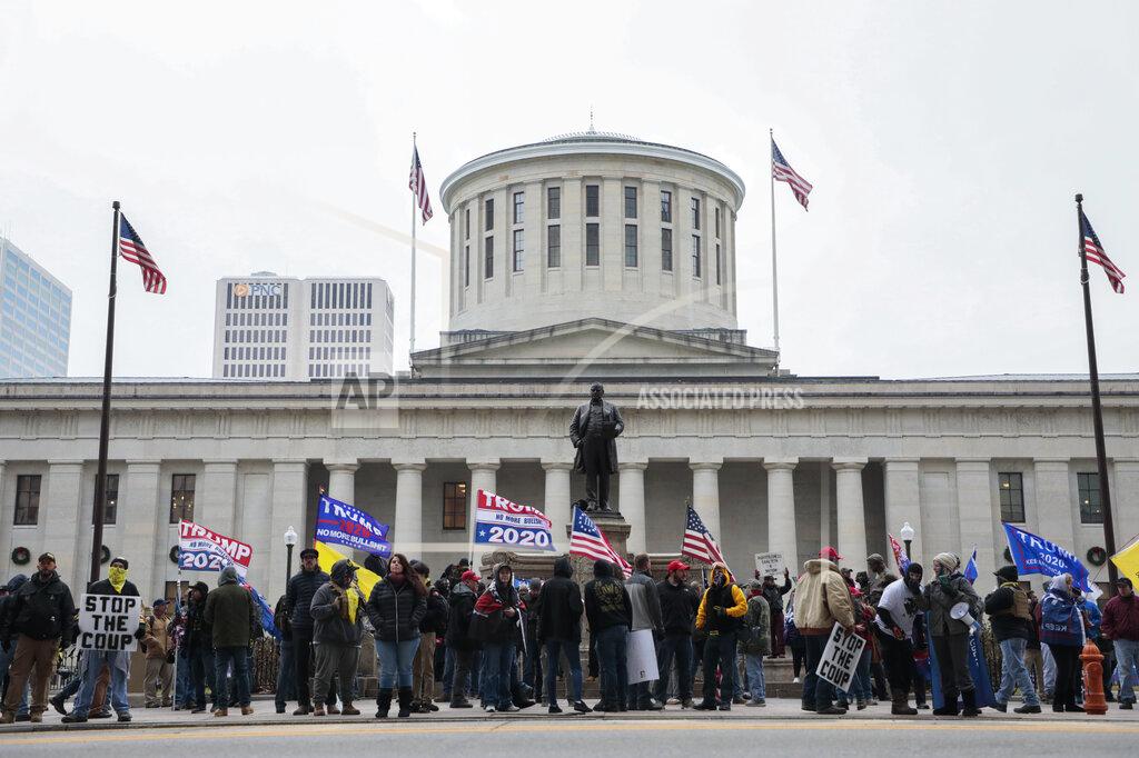 Joshua A. Bickel FILE - Supporters of President Donald Trump demonstrate during a rally on Wednesday, Jan. 6, 2021, at the Ohio Statehouse in Columbus, Ohio. Statehouses where Trump loyalists have rallied since the Nov. 3 election are heightening security after the storming of the U.S. Capitol this week. Police agencies in a number of states are monitoring threats of violence as legislatures return to session and as the nation prepares for the inauguration of President-elect Joe Biden. (Joshua A. Bickel/The Columbus Dispatch via AP, File)