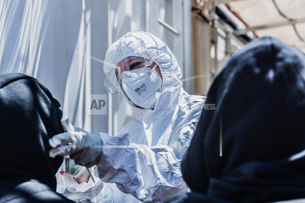 Flavio Gasperini A medical staffer conducts COVID-19 tests aboard the Ocean Viking ship in the Mediterranean Sea, Sunday, July 5, 2020. A humanitarian group says its rescue ship with 180 migrants stranded aboard for days has “finally” received instructions to sail to an Italian port, so its passengers can be disembarked. SOS Mediterranee in a tweet on Sunday also described “relief on the #Ocean Viking” when the ship's crew and passengers learned that the rescued migrants are to be disembarked at Porto Empedocle, Sicily, the next day. (Flavio Gasperini/SOS Mediterranee via AP)