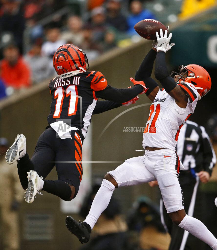 Gary Landers Cleveland Browns cornerback Denzel Ward (21) catches an interception against Cincinnati Bengals wide receiver John Ross (11) during the second half of an NFL football game, Sunday, Dec. 29, 2019, in Cincinnati. (AP Photo/Gary Landers)