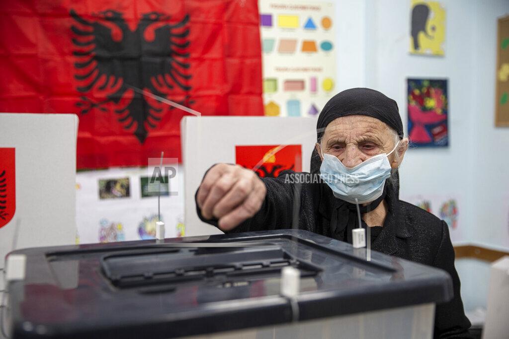 Visar Kryeziu An Albanian woman casts her vote ballot during parliamentary elections in capital Tirana, Albania on Sunday, April 25, 2021. Albanian voters have started casting ballots in parliamentary elections on Sunday amid the virus pandemic and a bitter political rivalry between the country's two largest political parties. (AP Photo/Visar Kryeziu)