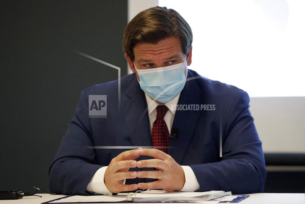 Florida Gov. Ron DeSantis listens during a news conference at the old Pan American Hospital during the coronavirus pandemic, Tuesday, July 7, 2020, in Miami. (AP Photo/Lynne Sladky)